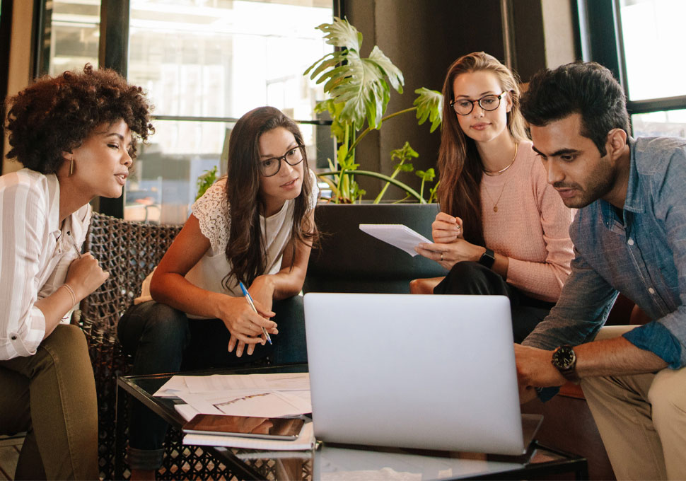 Group of people using a laptop